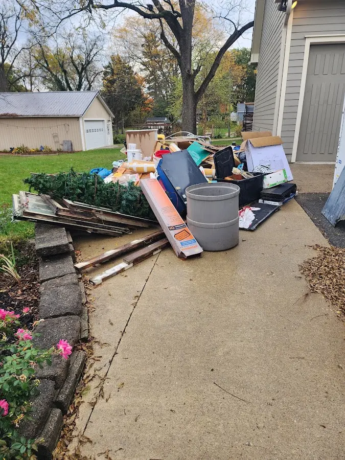 Dumpster being loaded with debris for Roofing Dumpster Rental in Whispering Pines